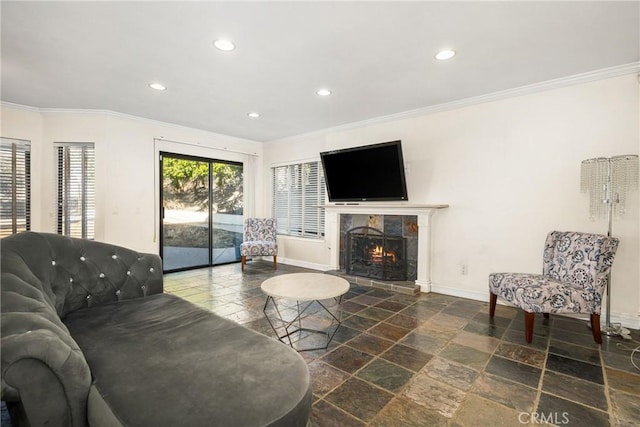 living room featuring ornamental molding and a fireplace