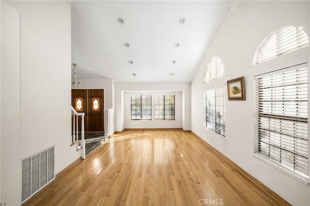 unfurnished living room featuring light hardwood / wood-style floors and high vaulted ceiling