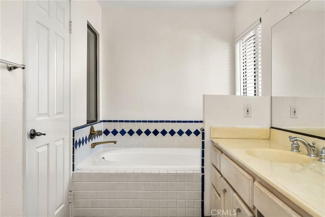 bathroom featuring a relaxing tiled tub and vanity