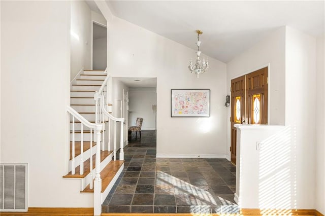 foyer featuring lofted ceiling and a notable chandelier