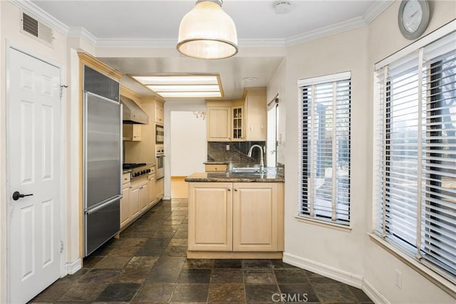 kitchen featuring wall chimney range hood, stainless steel appliances, decorative backsplash, sink, and kitchen peninsula