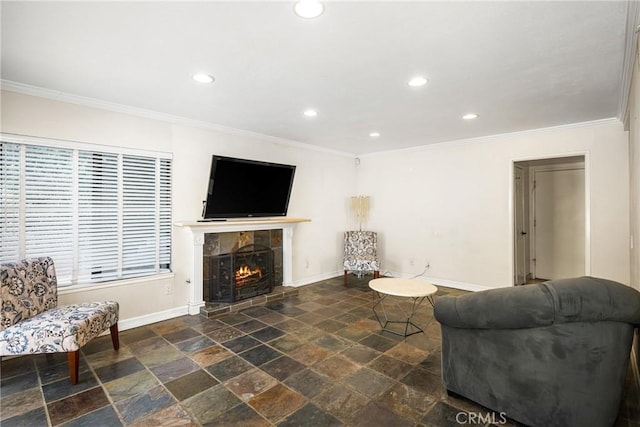 living room featuring crown molding and a tile fireplace