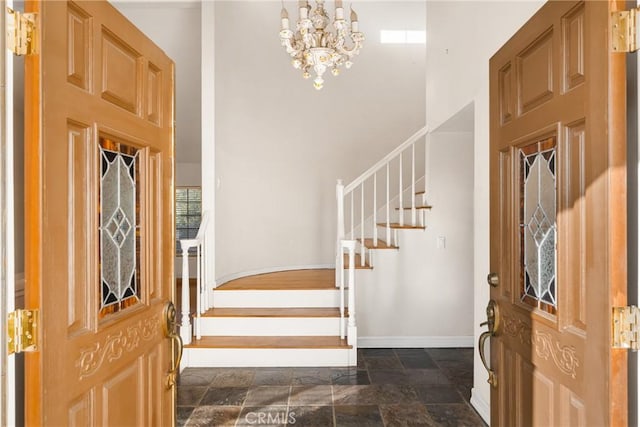 entryway with a chandelier