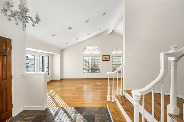 foyer featuring vaulted ceiling with beams and wood-type flooring