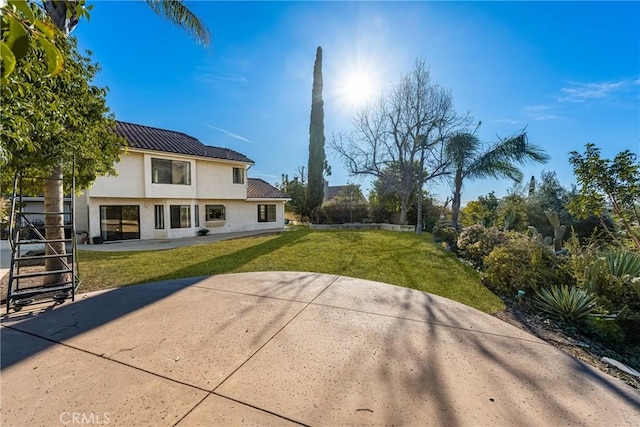 rear view of property with a lawn