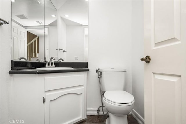 bathroom featuring toilet and vanity