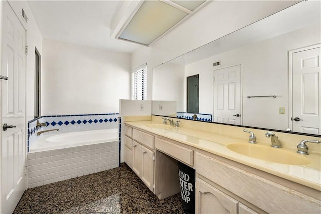 bathroom with a relaxing tiled tub and vanity