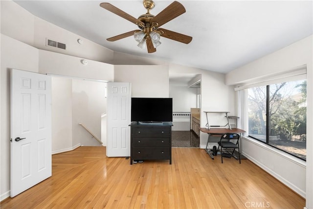 office with light hardwood / wood-style flooring and lofted ceiling