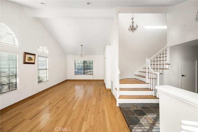 interior space with a chandelier, beamed ceiling, high vaulted ceiling, and wood-type flooring