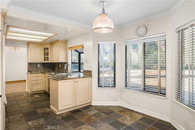 kitchen featuring crown molding, sink, dark stone countertops, pendant lighting, and backsplash