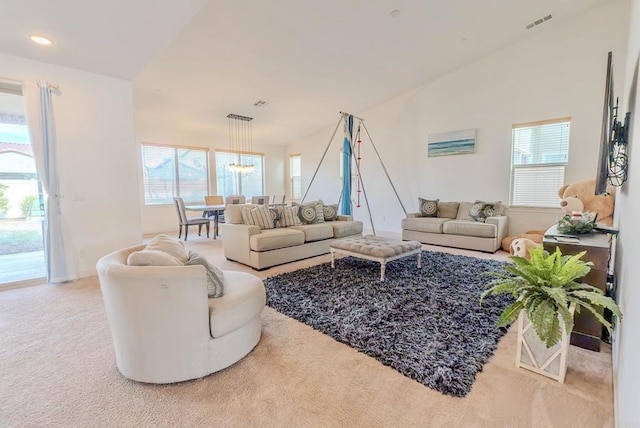 living room featuring lofted ceiling, plenty of natural light, and carpet flooring