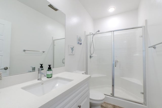 bathroom with vanity, toilet, and walk in shower