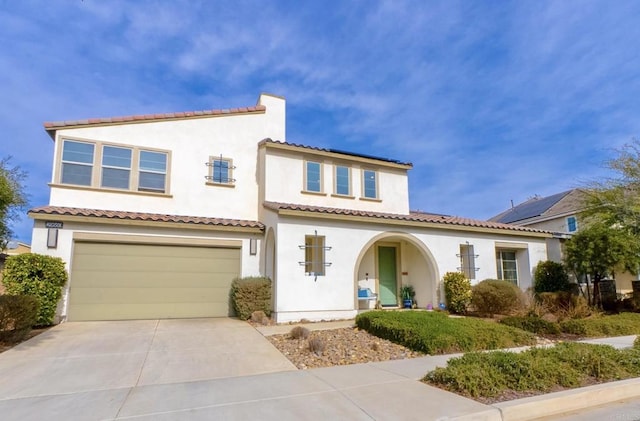 mediterranean / spanish-style home featuring a garage