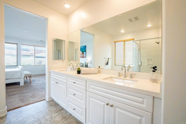 bathroom with vanity and a shower with door