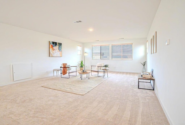 living area featuring light carpet