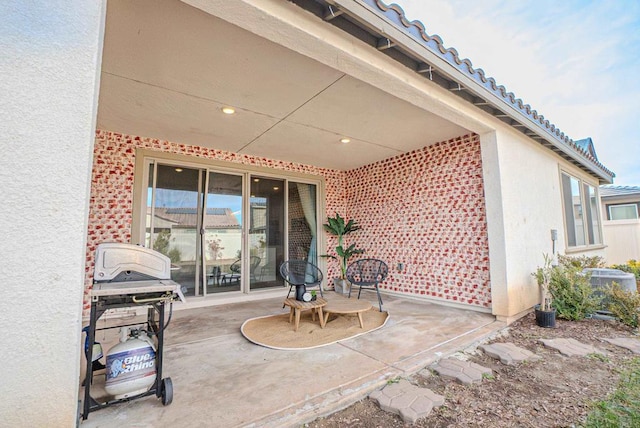 view of patio featuring central AC and grilling area