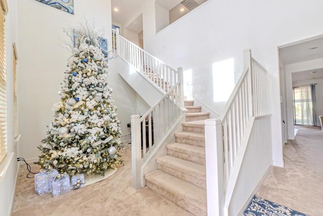 staircase with a high ceiling