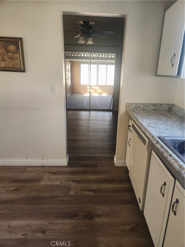 kitchen with white cabinets, dark hardwood / wood-style floors, and white dishwasher