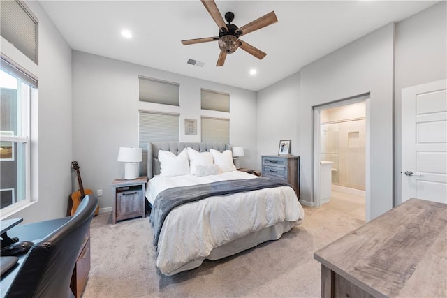 carpeted bedroom with ceiling fan and ensuite bath