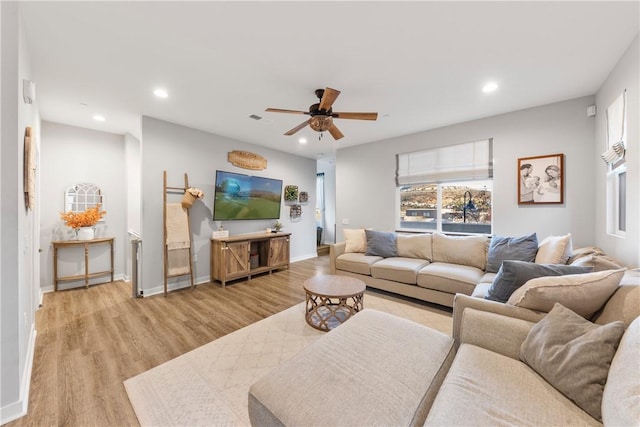 living room with light wood-type flooring and ceiling fan