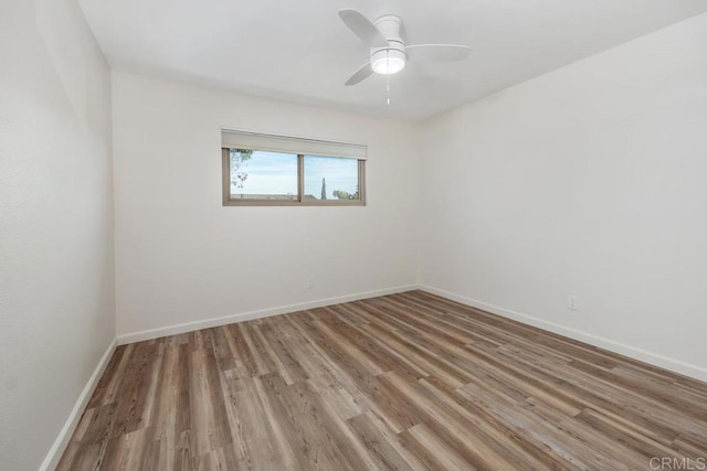 unfurnished room with hardwood / wood-style flooring and ceiling fan