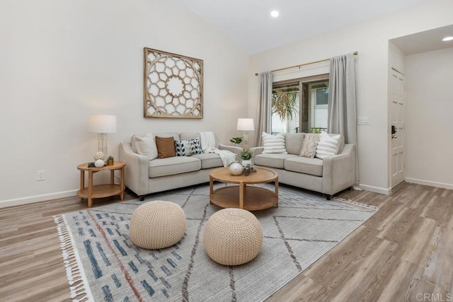 living room featuring light hardwood / wood-style floors and lofted ceiling