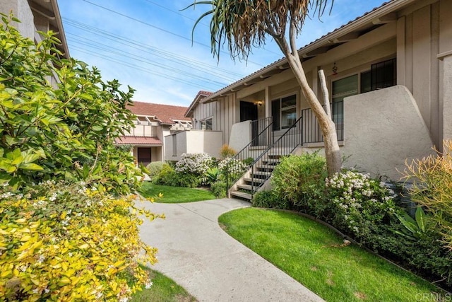 property entrance with a lawn