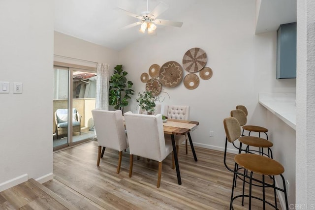 dining space featuring light hardwood / wood-style flooring, vaulted ceiling, and ceiling fan