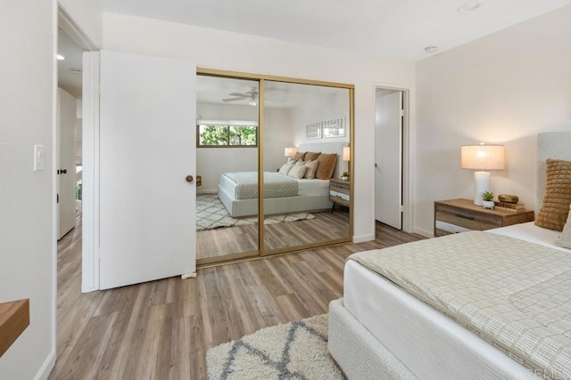 bedroom with a closet and light hardwood / wood-style floors