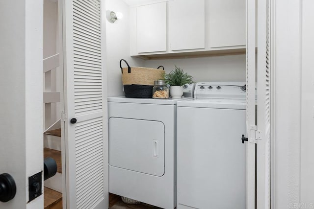 washroom with cabinets and washer and dryer