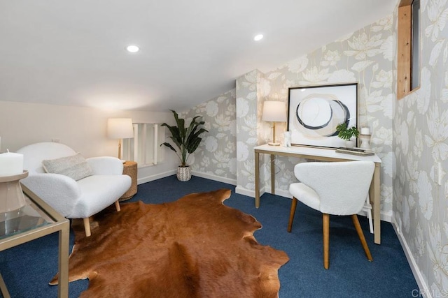 office with dark colored carpet and vaulted ceiling