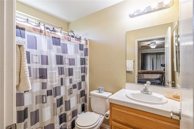 bathroom with vanity, toilet, and a shower with curtain