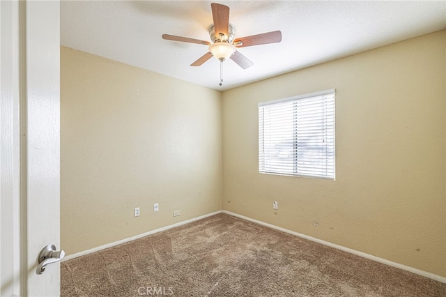 unfurnished room with ceiling fan and carpet flooring