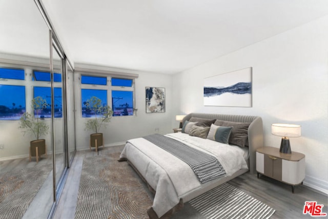 bedroom with dark wood-type flooring