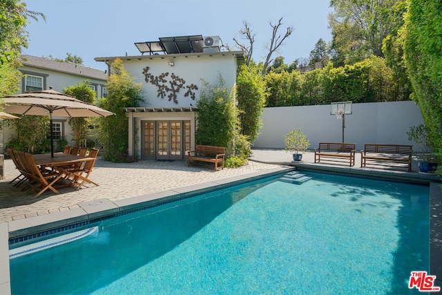 view of pool with a patio area and an outdoor structure