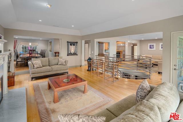 living room with light hardwood / wood-style flooring and lofted ceiling