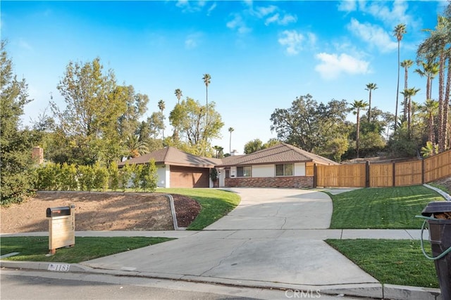 ranch-style house with a garage and a front lawn