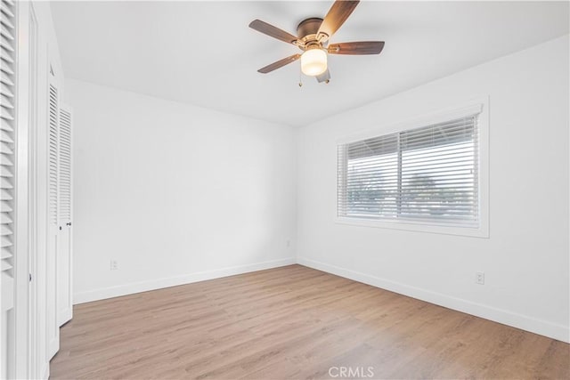 unfurnished bedroom featuring light hardwood / wood-style flooring, ceiling fan, and a closet