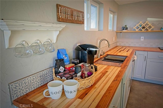 kitchen featuring butcher block counters and sink