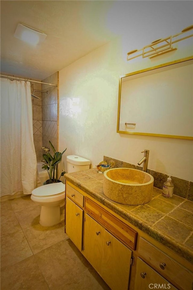 full bathroom with vanity, shower / bath combination with curtain, and toilet