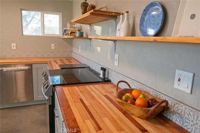 kitchen featuring butcher block counters, hardwood / wood-style floors, and stainless steel appliances