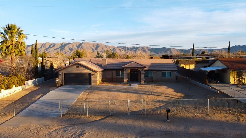 single story home featuring a garage and a mountain view