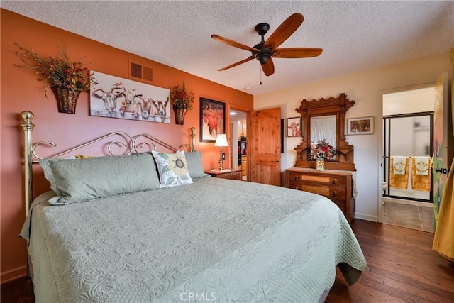 bedroom with ceiling fan, dark wood-type flooring, and a textured ceiling