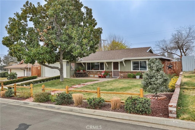 single story home featuring a garage and a front lawn