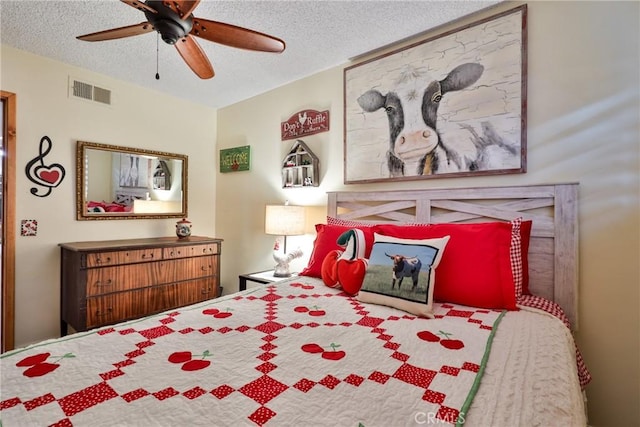 bedroom with ceiling fan and a textured ceiling