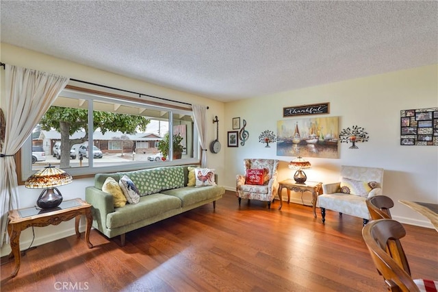 living room with hardwood / wood-style floors and a textured ceiling