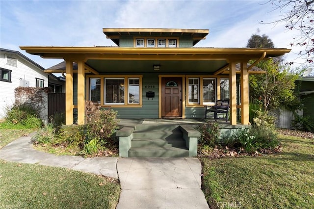 view of front of home featuring covered porch and a front lawn