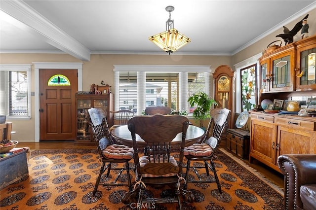 dining space featuring ornamental molding and dark hardwood / wood-style flooring