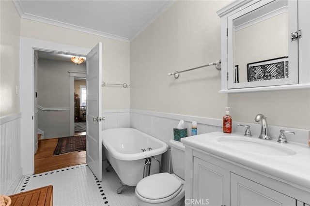 bathroom featuring a tub to relax in, tile patterned floors, toilet, and ornamental molding