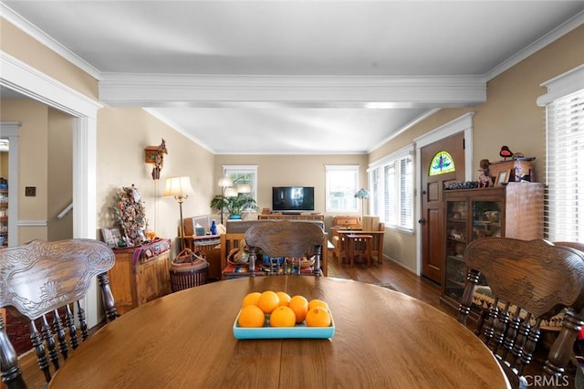 dining space featuring hardwood / wood-style floors and crown molding